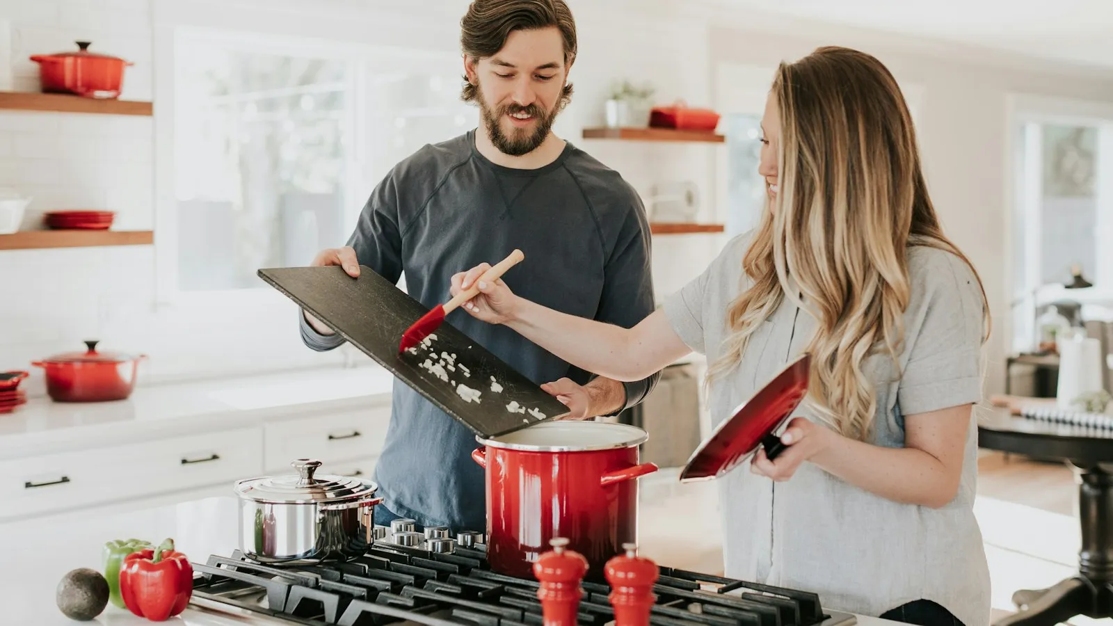 Couple cooking together in a bright remodeled kitchen